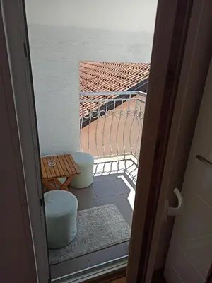 a view of a balcony with a table and a bench at Cozy studio Belgrade (Zemun) in Belgrade