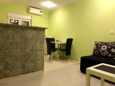 a living room with a couch and a table with chairs at MARE Apartmant in Belgrade