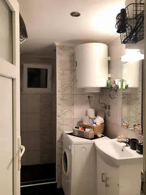 a bathroom with a washing machine and a sink at MARE Apartmant in Belgrade