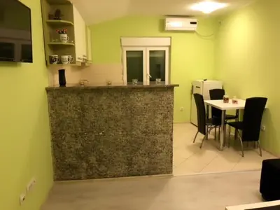 a kitchen with a counter and a table with chairs at MARE Apartmant in Belgrade