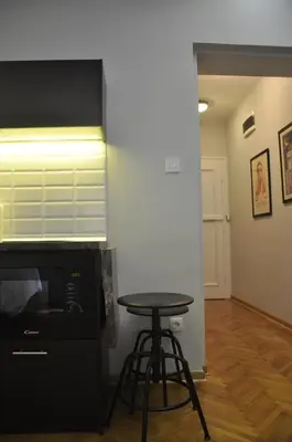a kitchen with a table and a microwave at Urban Studio in city center in Belgrade