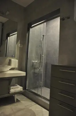 a bathroom with a shower with a glass door at Urban Studio in city center in Belgrade