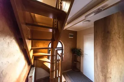 a spiral staircase in a room with a hallway at Talismano Apartments in Smederevo