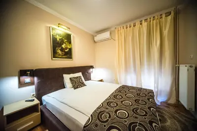 a bedroom with a large bed and a window at Talismano Apartments in Smederevo