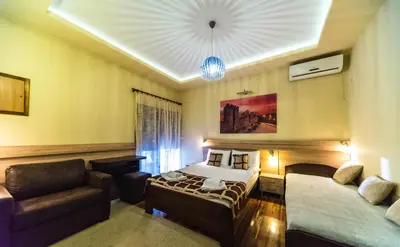 a hotel room with a bed and a couch at Talismano Apartments in Smederevo