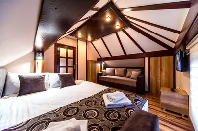 a bedroom with a large bed and a couch at Talismano Apartments in Smederevo