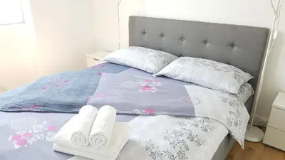 a bed with two towels and two pillows on it at Krunska 54 in Belgrade