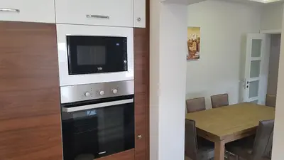 a kitchen with a stove and a table with a microwave at Krunska 54 in Belgrade