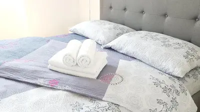 a bed with two towels and two pillows on it at Krunska 54 in Belgrade