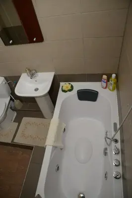 a bathroom with a white tub and a sink at Apartments Skadarlija in Belgrade