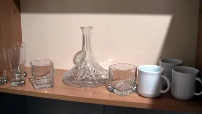 a glass vase and glasses sitting on a shelf at Apartments Skadarlija in Belgrade