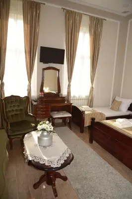 a room with a bedroom with a bed and a mirror at Apartments Skadarlija in Belgrade