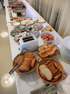 a table with bread and eggs and baskets of food at Konak Vukasinovic - FREE PARKING in Belgrade