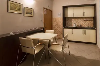 a kitchen and dining room with a table and chairs at Konak Vukasinovic - FREE PARKING in Belgrade