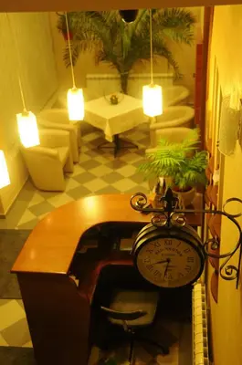 a room with a desk and a clock in a room at Konak Vukasinovic - FREE PARKING in Belgrade
