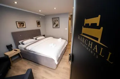 a bedroom with a bed with white sheets at Marshal apartment in Belgrade
