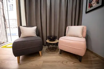 two chairs and a table in a room at Marshal apartment in Belgrade