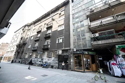 a large building on a city street with a store at Marshal apartment in Belgrade