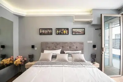 a bedroom with a large bed and two pictures on the wall at Marshal apartment in Belgrade