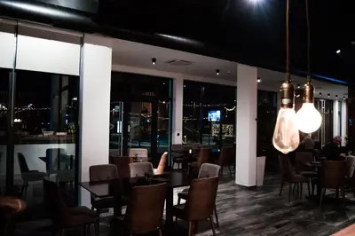 a restaurant with tables and chairs and lights at Hotel Ub Business & Wellness in Ub