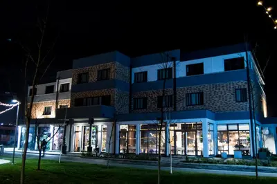 a building at night with christmas lights at Hotel Ub Business & Wellness in Ub