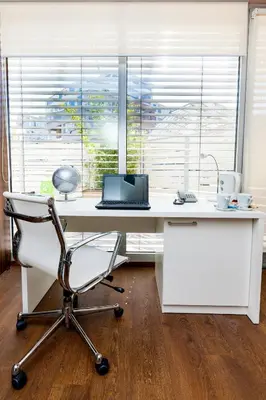 an office with a desk with a chair and a laptop at Adresa Suites in Belgrade