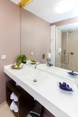 a bathroom with a sink and a large mirror at Adresa Suites in Belgrade