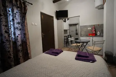 a bedroom with a bed with purple towels on it at Apartman Rale in Belgrade