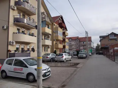 a white car parked in front of a building at MaryAnne in Ledine