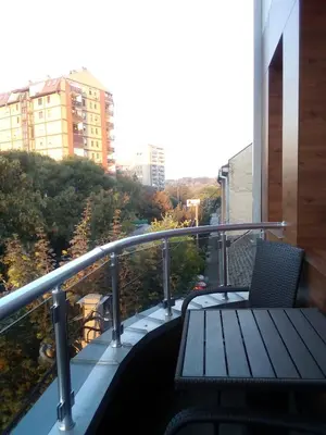 a balcony with a wooden bench on a building at Konak Kutko in Pančevo