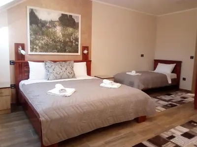 a hotel room with two beds with towels on them at Konak Kutko in Pančevo