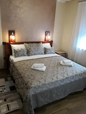 a bedroom with a large bed with towels on it at Konak Kutko in Pančevo