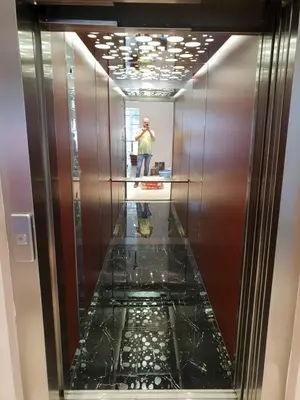 a man taking a picture of a elevator at Konak Kutko in Pančevo