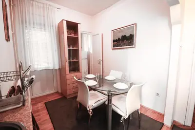 a dining room with a table and white chairs at Apartment Petra 071 in Belgrade