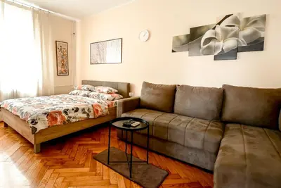 a living room with a couch and a bed at Apartment Petra 071 in Belgrade