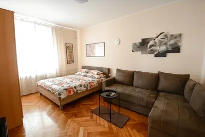 a living room with a couch and a bed at Apartment Petra 071 in Belgrade