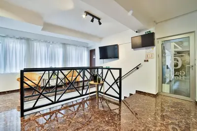 a room with a balcony with a tv at Garni House 46 Plus in Belgrade
