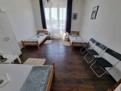 a room with beds and benches in a room at Downtown Belgrade Hostel and Apartments in Belgrade