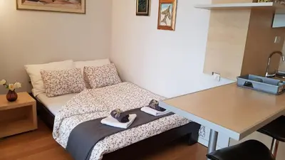 a small room with a bed with shoes on it at Downtown Belgrade Hostel and Apartments in Belgrade