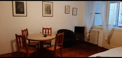 a room with a table and chairs and a bedroom at Downtown Belgrade Hostel and Apartments in Belgrade