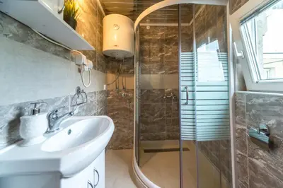 a bathroom with a sink and a shower at Lux Apartment in Downtown in Belgrade