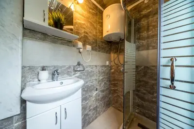 a bathroom with a sink and a shower at Lux Apartment in Downtown in Belgrade