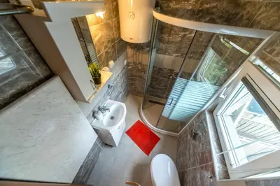 an overhead view of a bathroom with a shower and a sink at Lux Apartment in Downtown in Belgrade