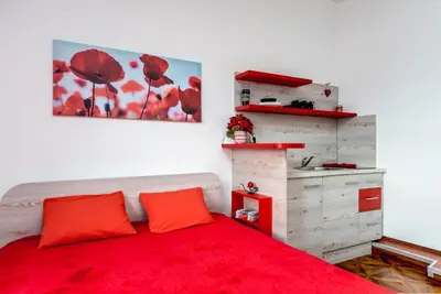 a bedroom with a red bed and a red blanket at Lux Apartment in Downtown in Belgrade
