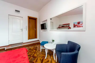 a living room with a table and two chairs at Lux Apartment in Downtown in Belgrade