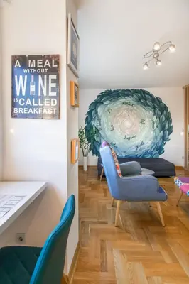 a living room with blue chairs and a table at VortexLuxApatman in Belgrade