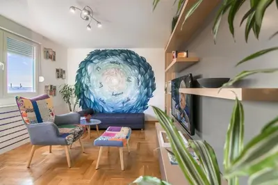 a living room with a blue couch and chairs at VortexLuxApatman in Belgrade