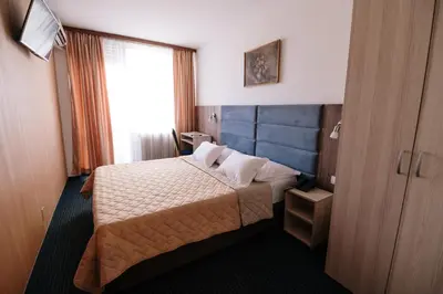 a hotel room with a bed and a window at Hotel Slavija in Belgrade