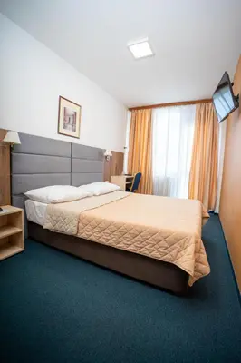 a hotel room with a bed and a window at Hotel Slavija in Belgrade