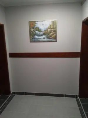 a room with a painting on the wall and a tile floor at Djurdja 2 Apartman in Arandjelovac